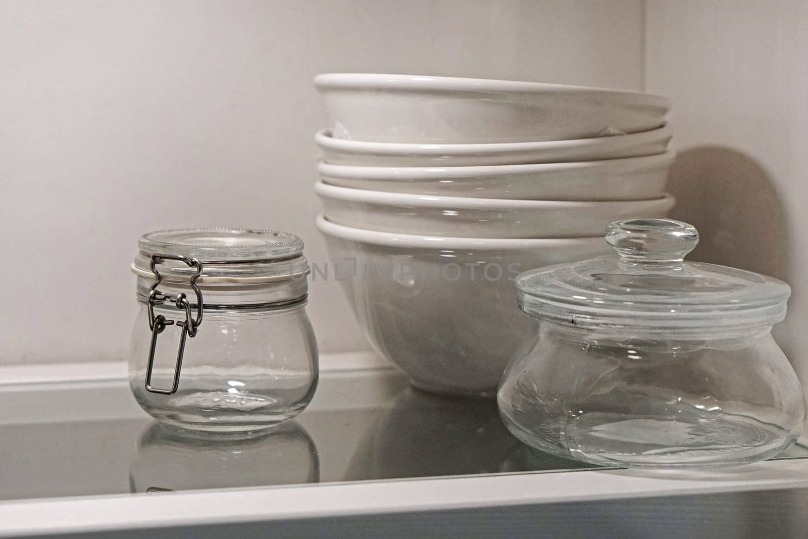Bowls and jars dishes at glass shelf