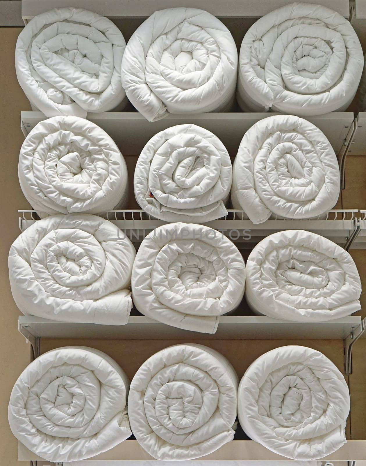 Many clean white duvets blankets in rolls