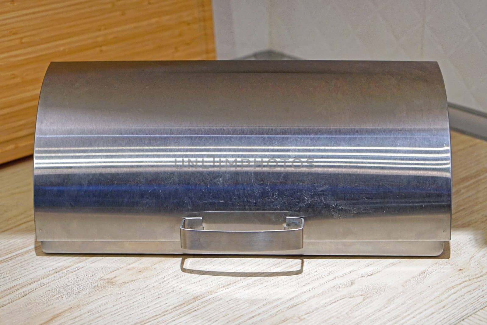 Closed stainless steel bread box at kitchen countertop