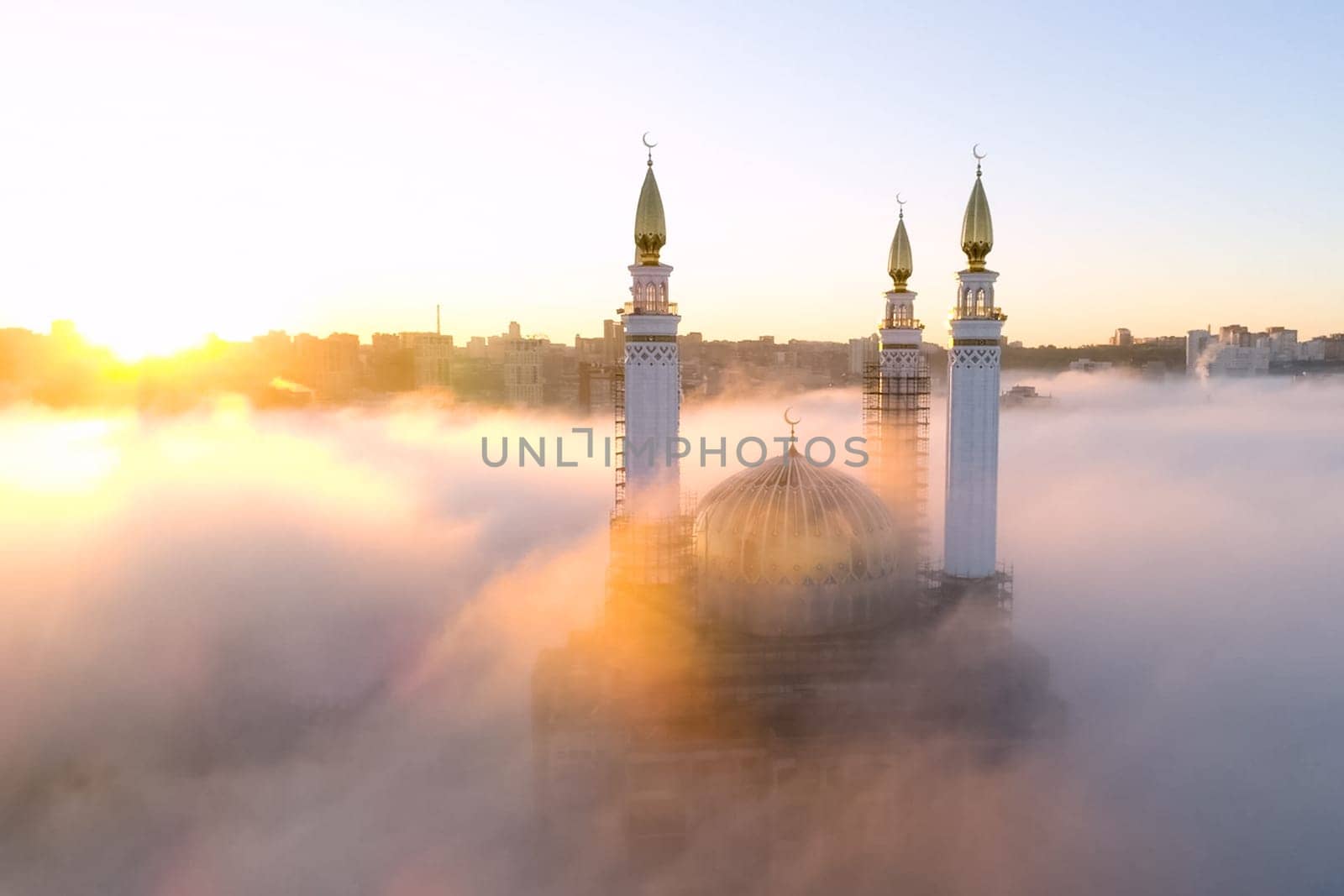 The Kazan Mosque is shrouded in mist at dawn. View from above.