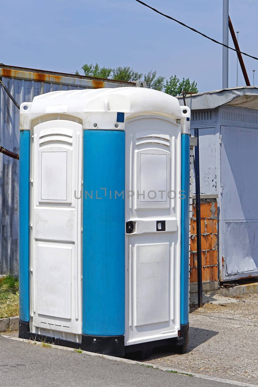 Portable toilet cabin at open construction site