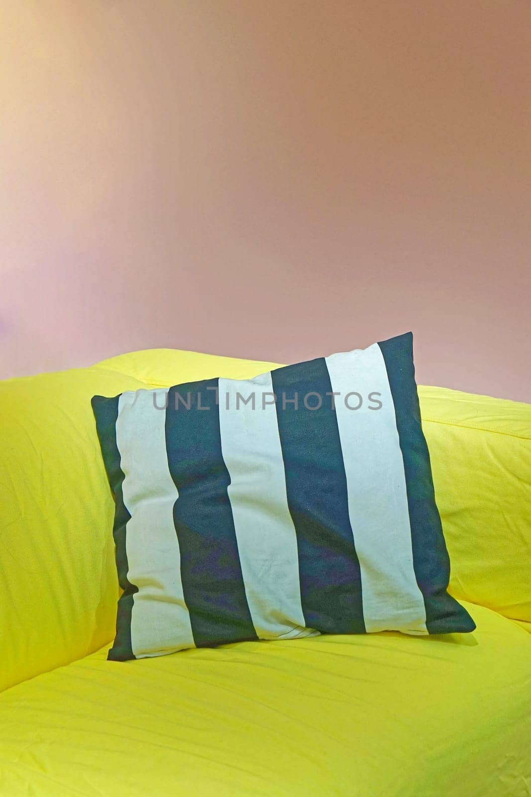 Soft pillow cushion with straps at green sofa