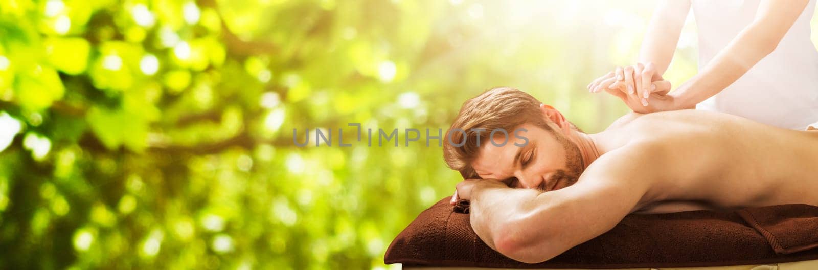 Portrait Of A Young Man Receiving Back Massage At A Beauty Spa