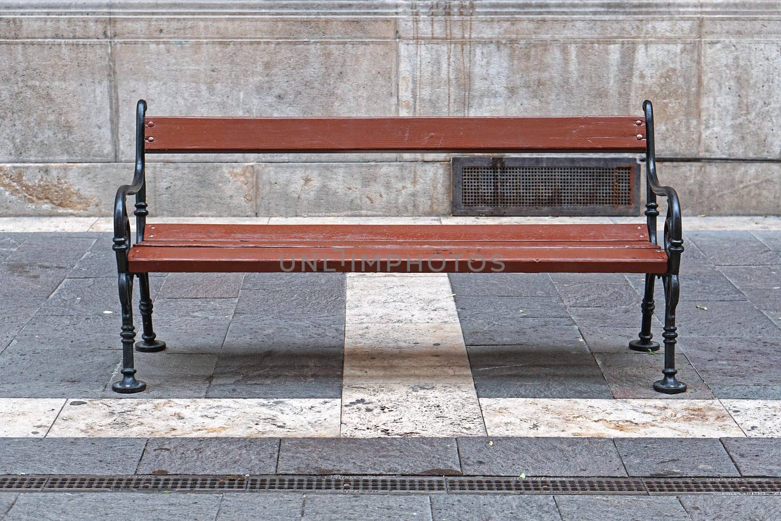 Empty brown wood bench at street