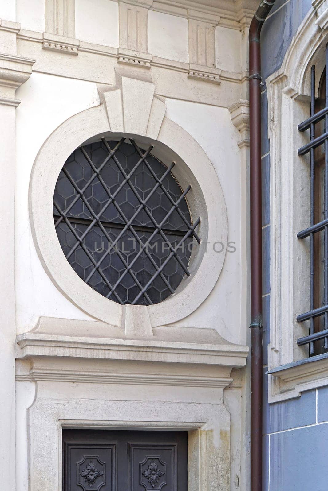 Round window with bars above door