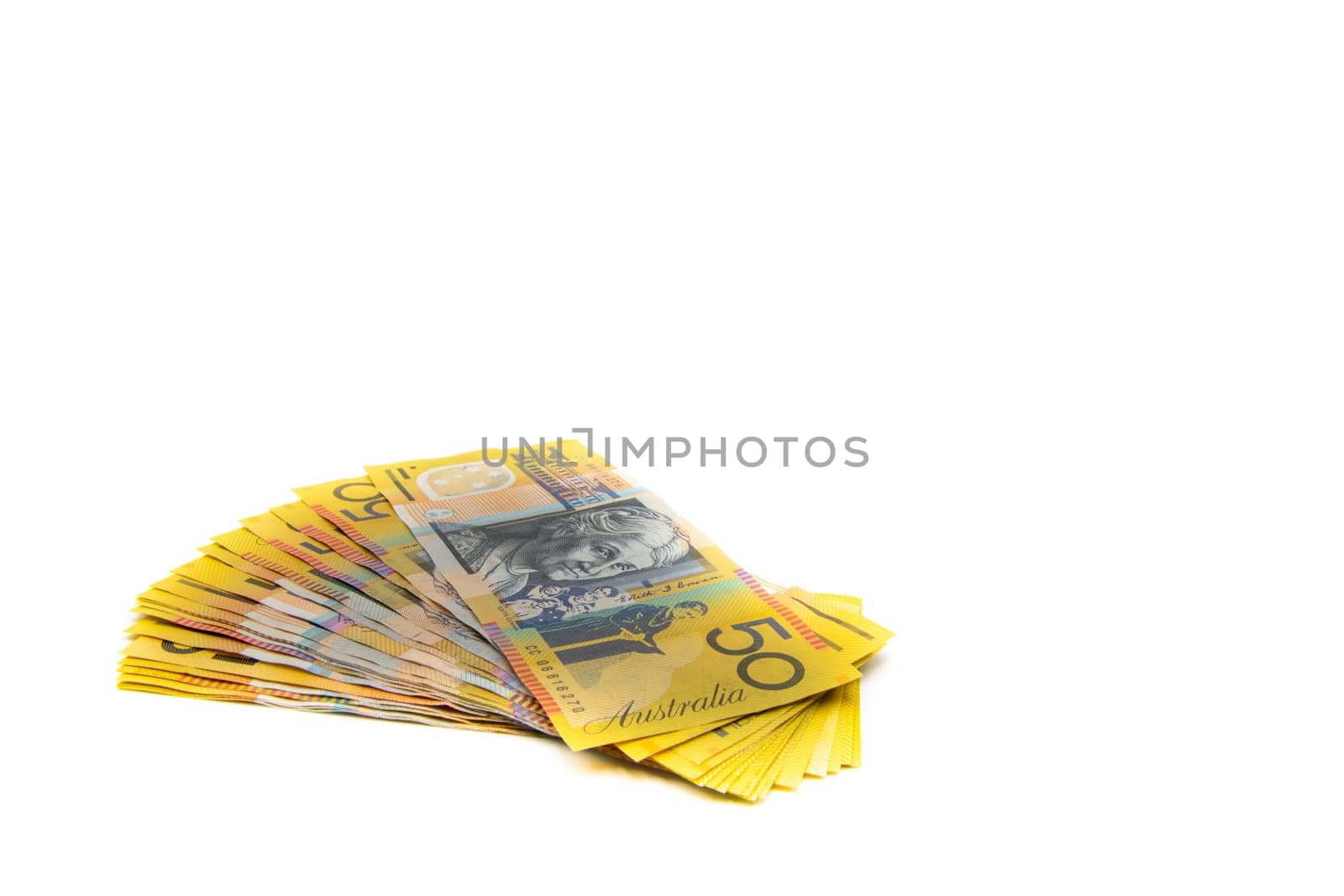 Stack of Australian 50 dollars banknotes isolated over white background with copy space, cash is king concept image