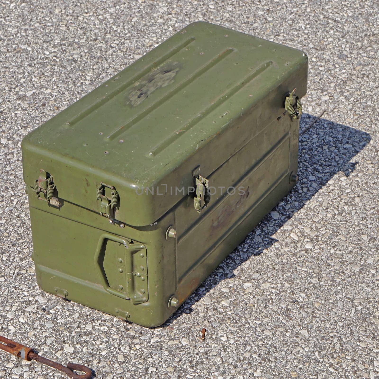 Green metal army ammo box at street