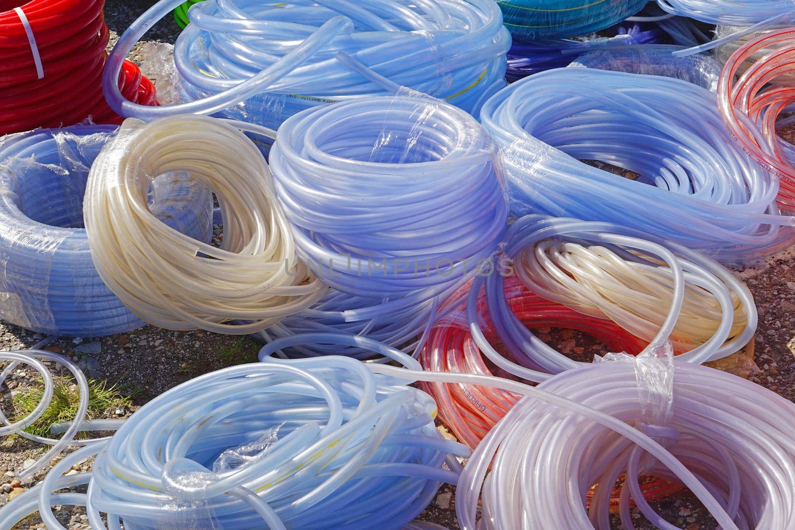 Many new garden hoses in coils