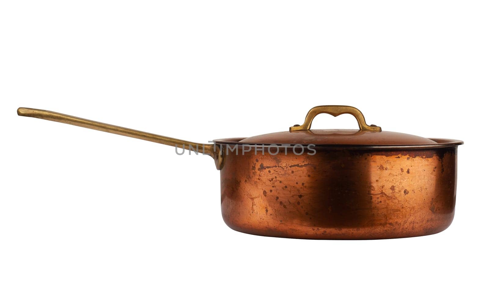 side view closeup of old cooking pan with copper lid and metallic handle isolated on white background