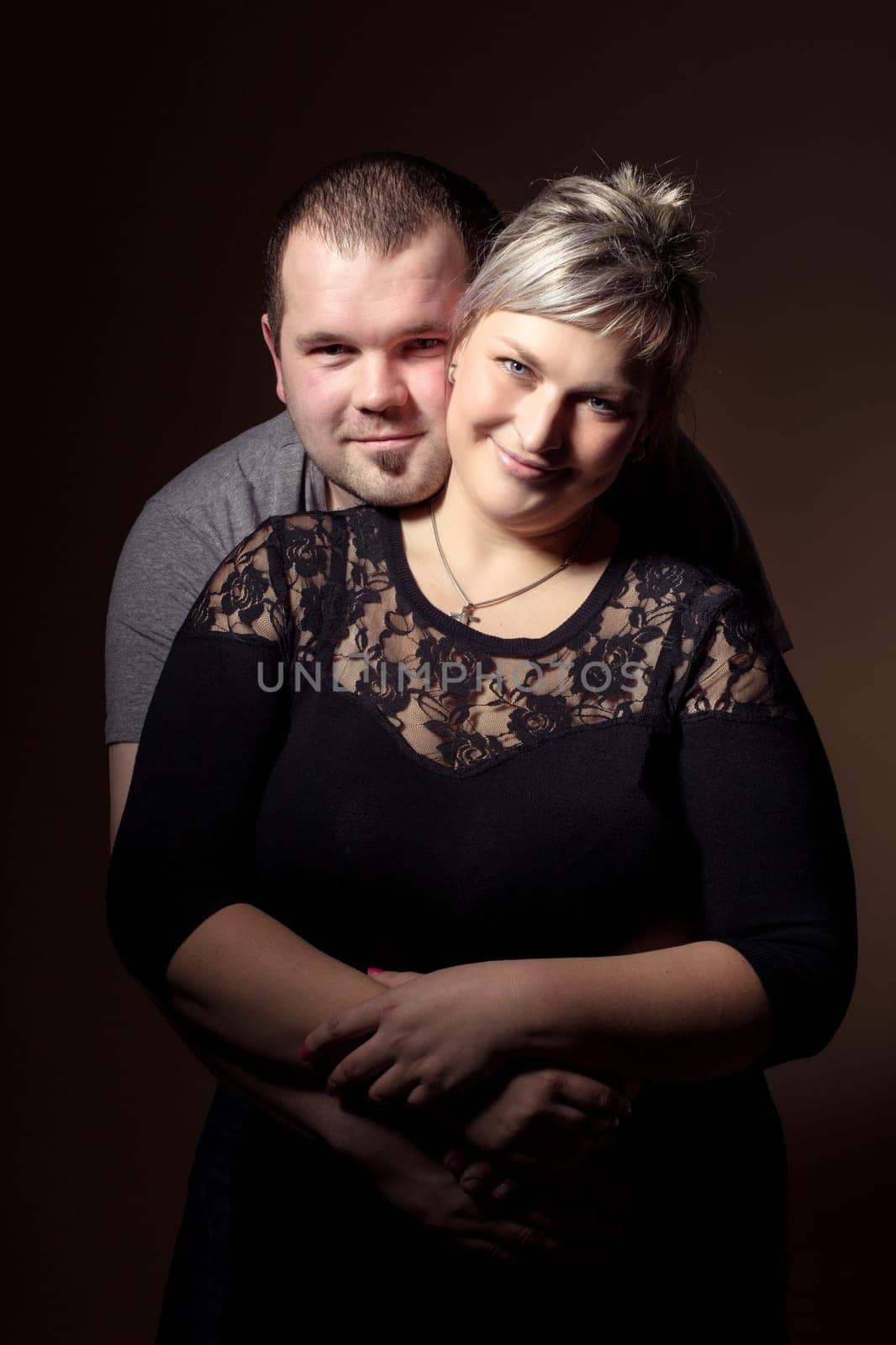 Studio shoot of beautiful fashion xxl woman with her husband, happy couple love concept