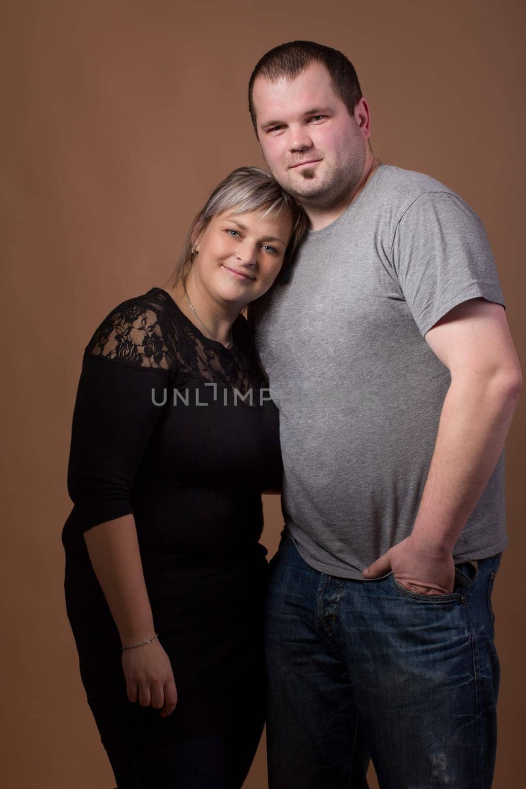Studio shoot of beautiful fashion xxl woman with her husband, happy couple love concept