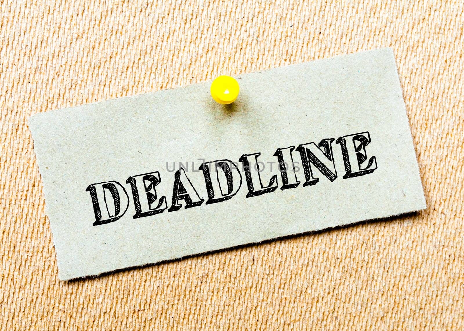 Recycled paper note pinned on cork board. Deadline message. Concept Image