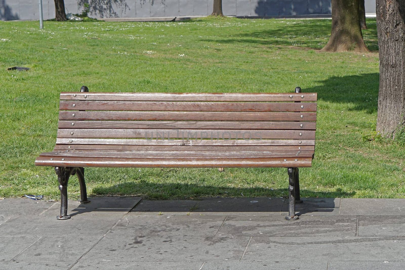 Classic style wooden bench in city park