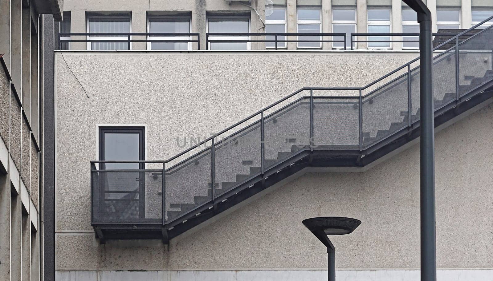 Metal staircase with banister at building exterior