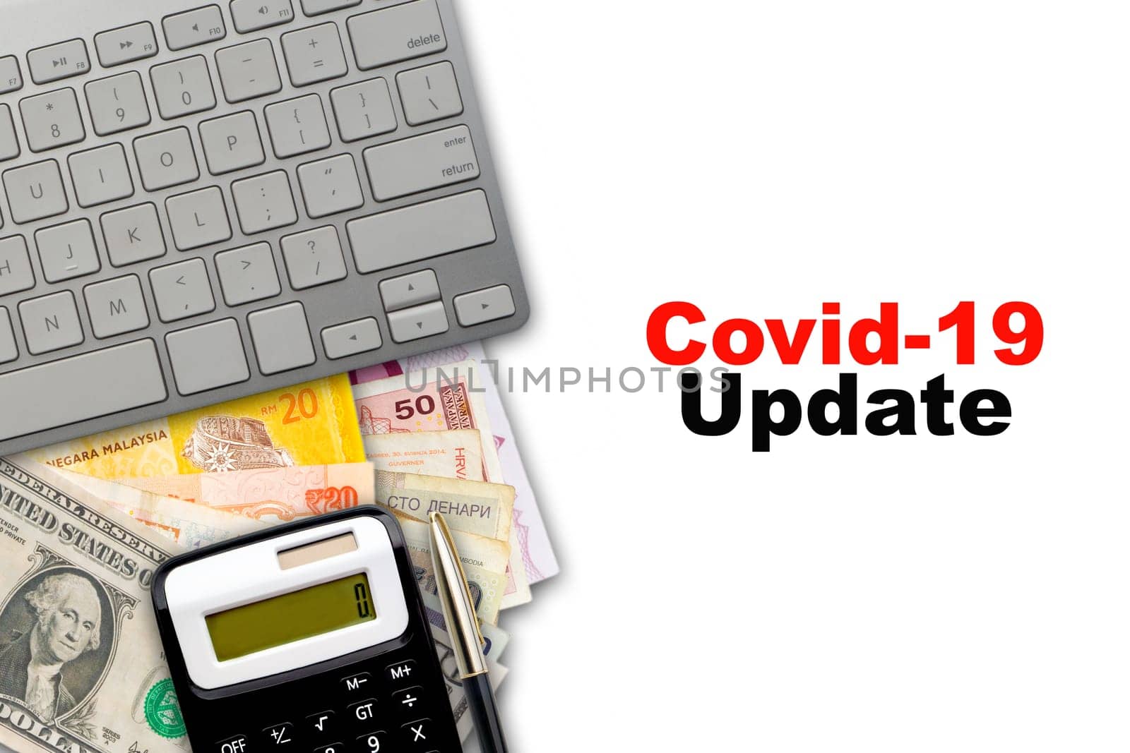 COVID 19 UPDATE text with fountain pen, keyboard, calculator and currency banknotes on white background. Business Concept
