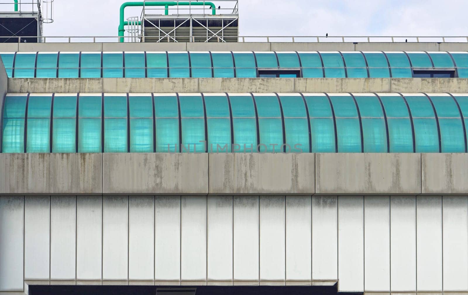 Modern airport building exterior with green windows