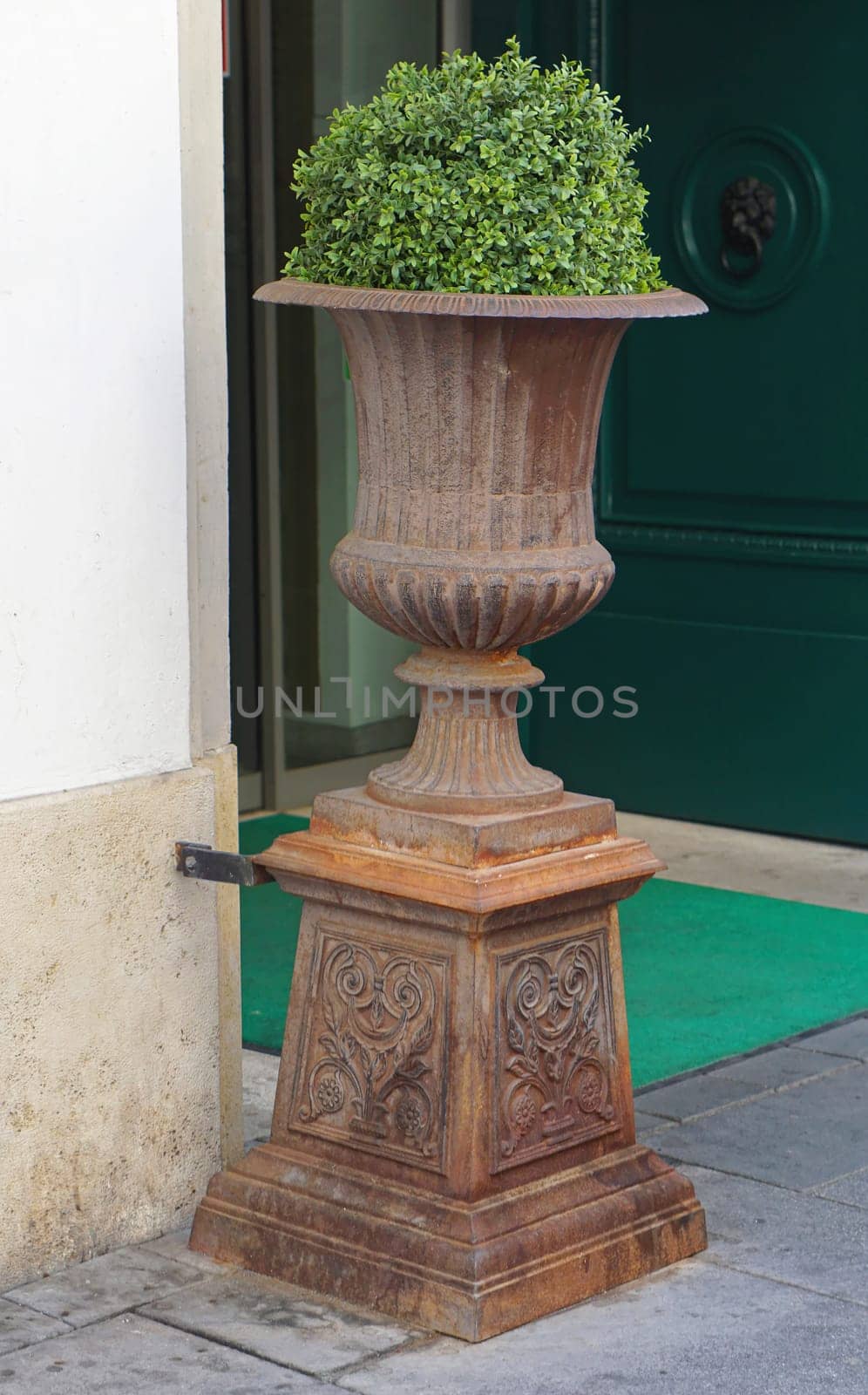 Ancient style plant pot in front of building
