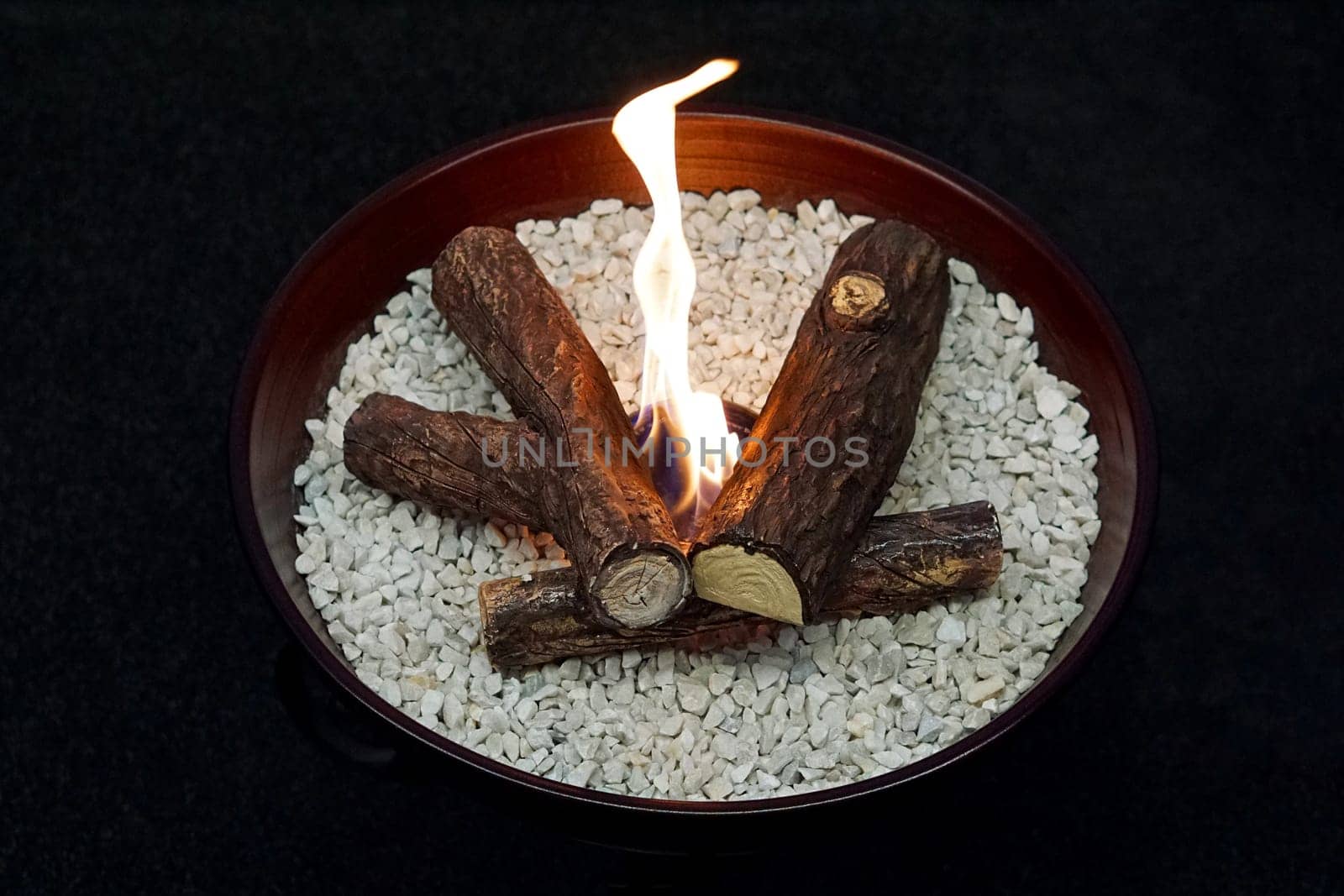 Fake fire in decorative tray at home