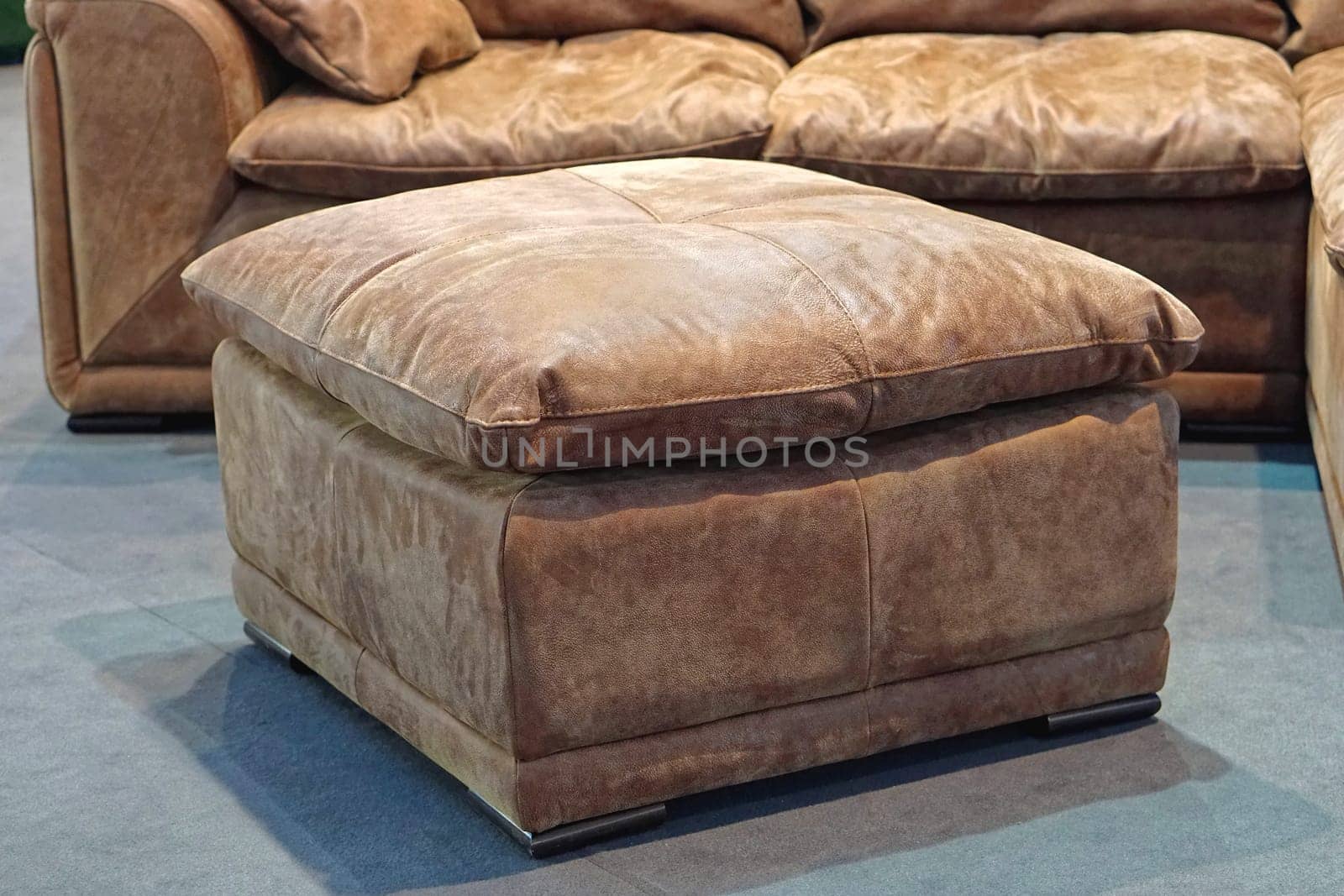 Big leather footstool in living room