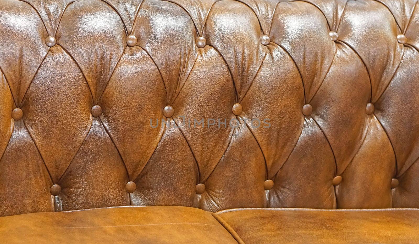 Brown leather sofa backrest upholstery pattern