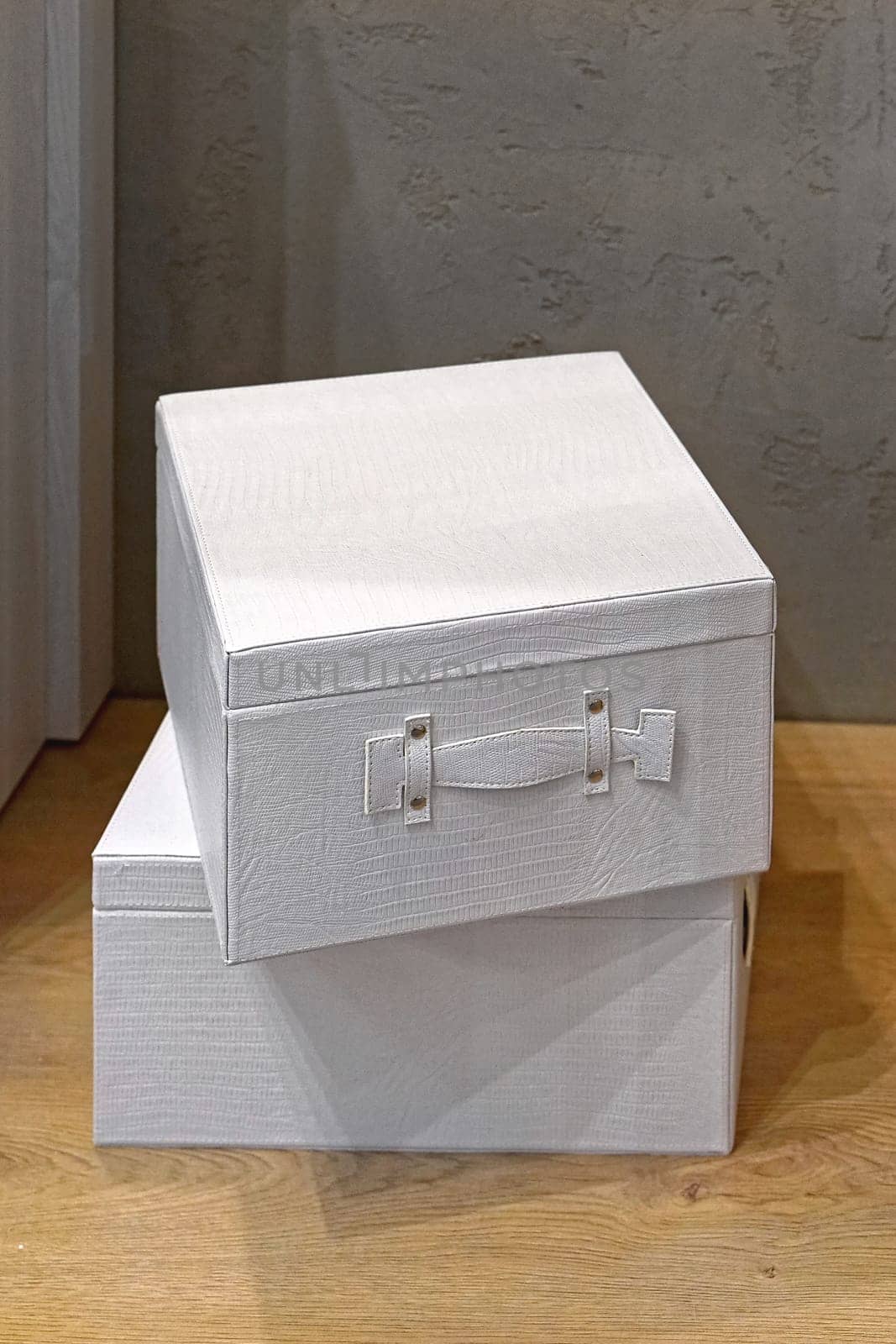 Two white boxes stacked at floor