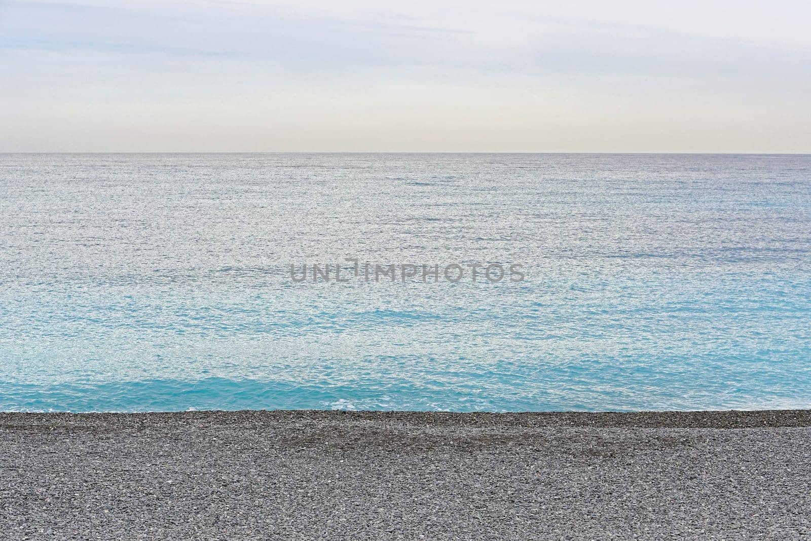 Pebbles beach at Mediterranean sea shore in France