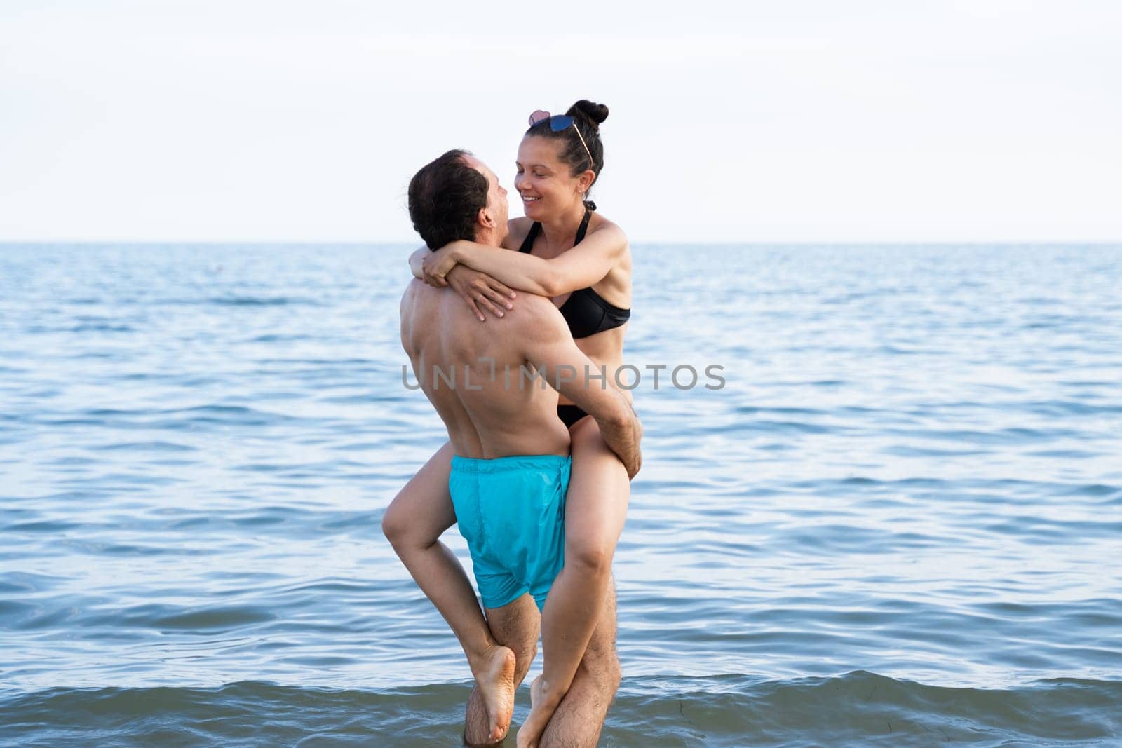 Lifting Woman At Beach At Sea In Summer