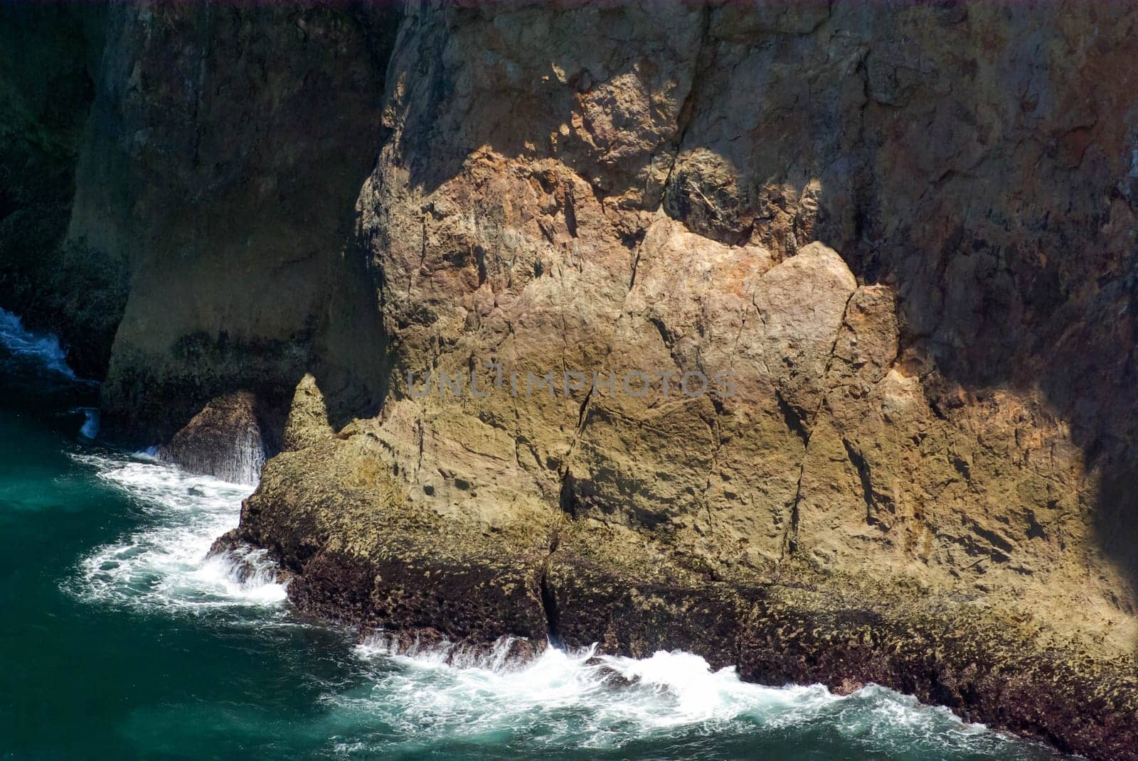 Magnificent colorful rough textured rock and flowing water at base with copy space.