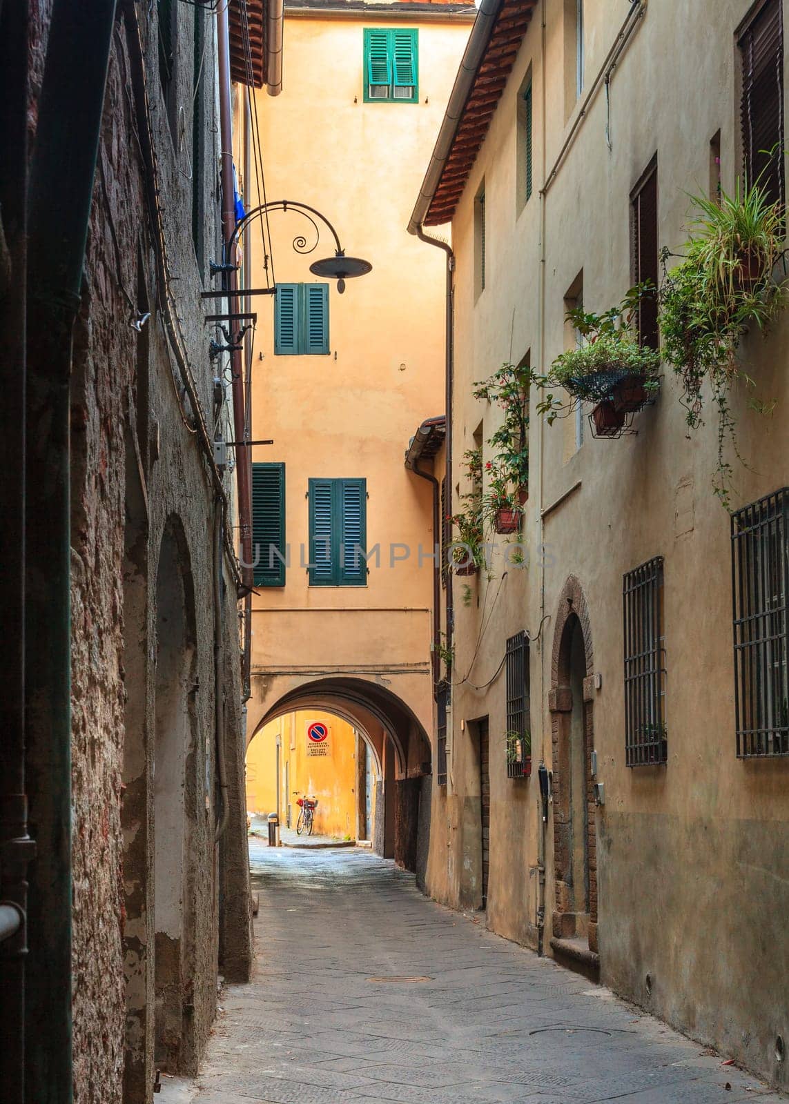 Narrow residential street in the historic part of Lucca, Italy