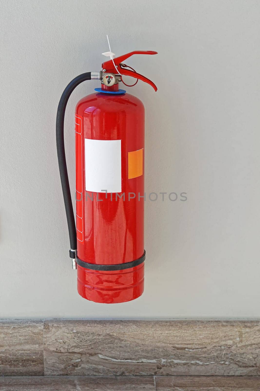 Fire extinguisher protection device at wall