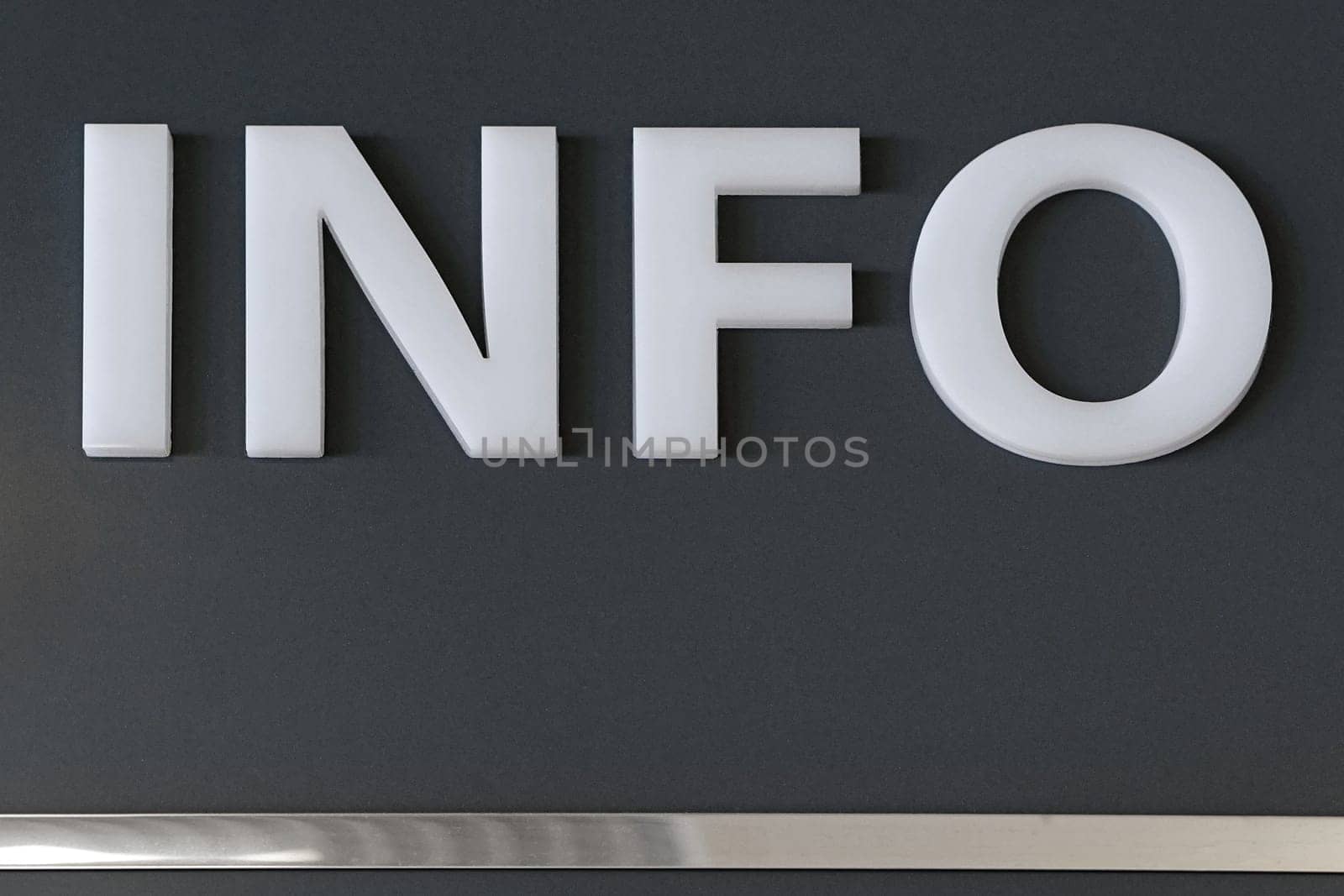 White 3d plastic letters info at wall