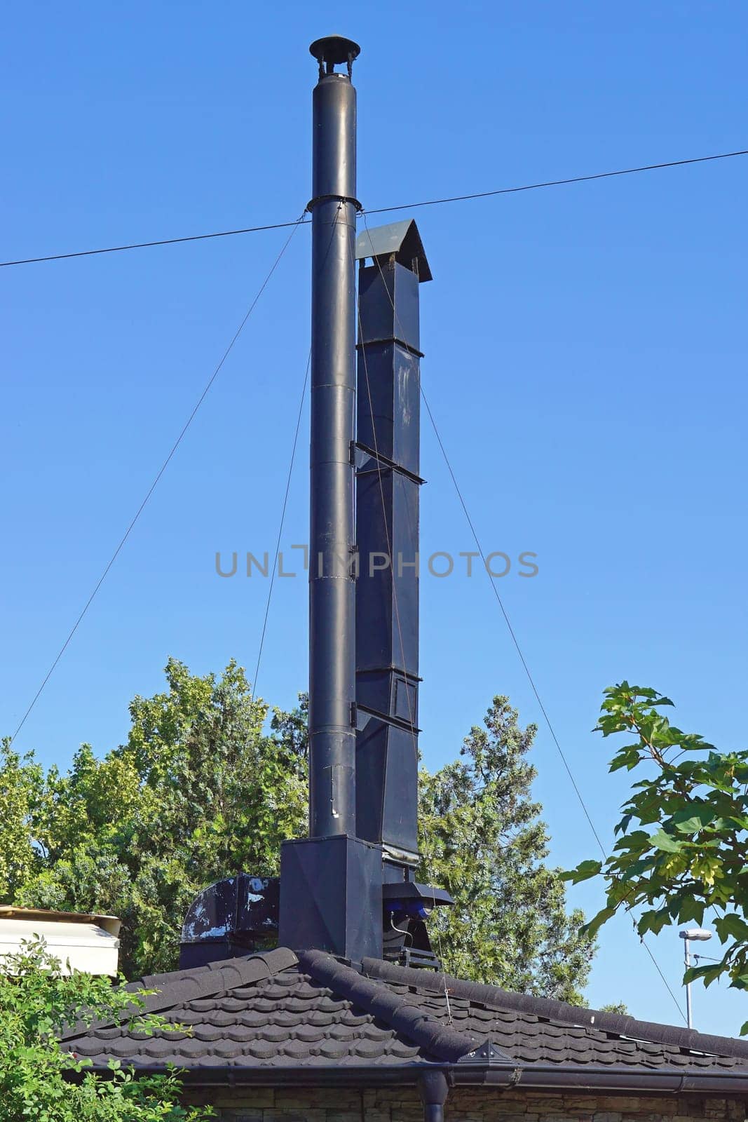 Two black metal chimneys at grill