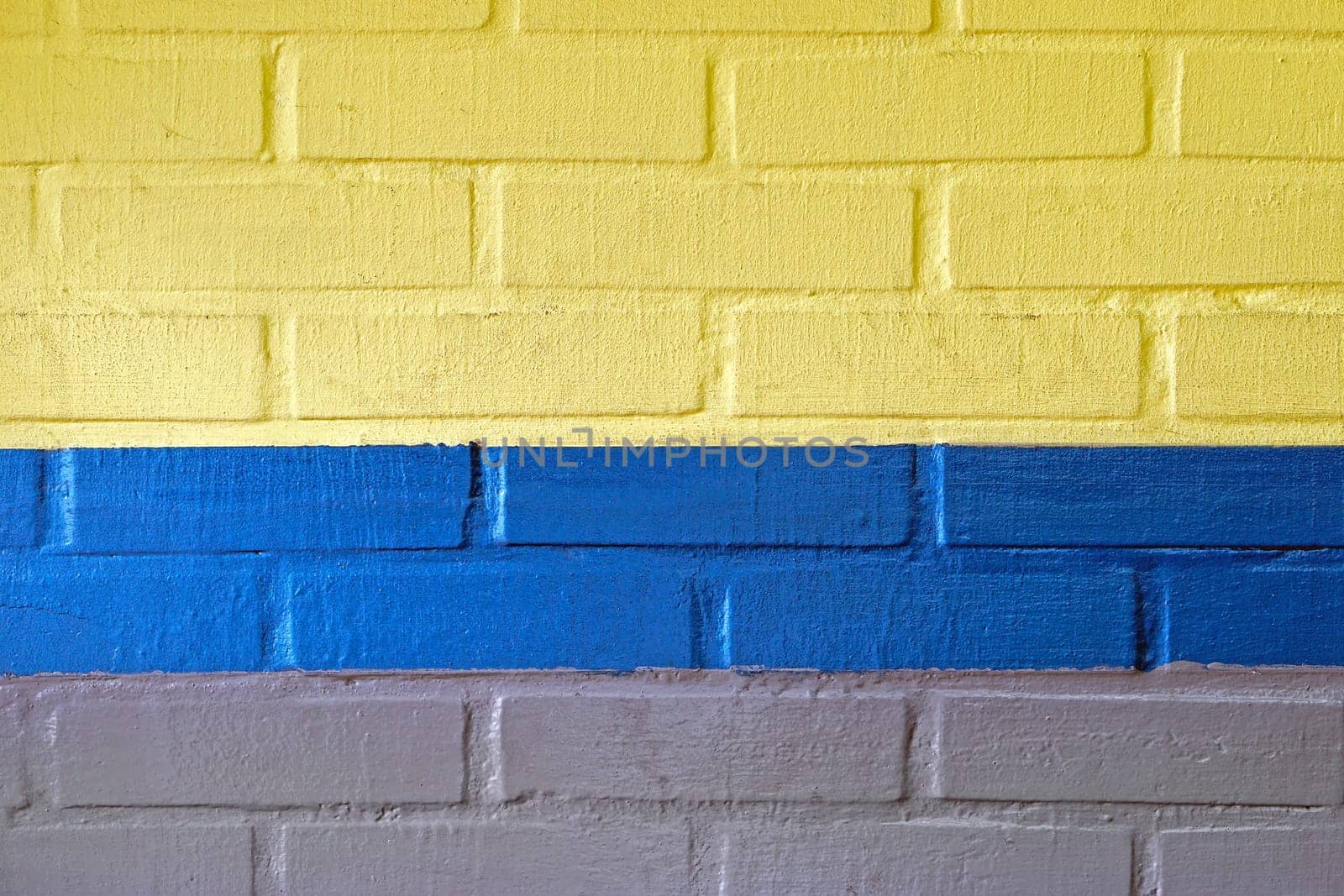 Yellow blue and grey wall made from bricks background