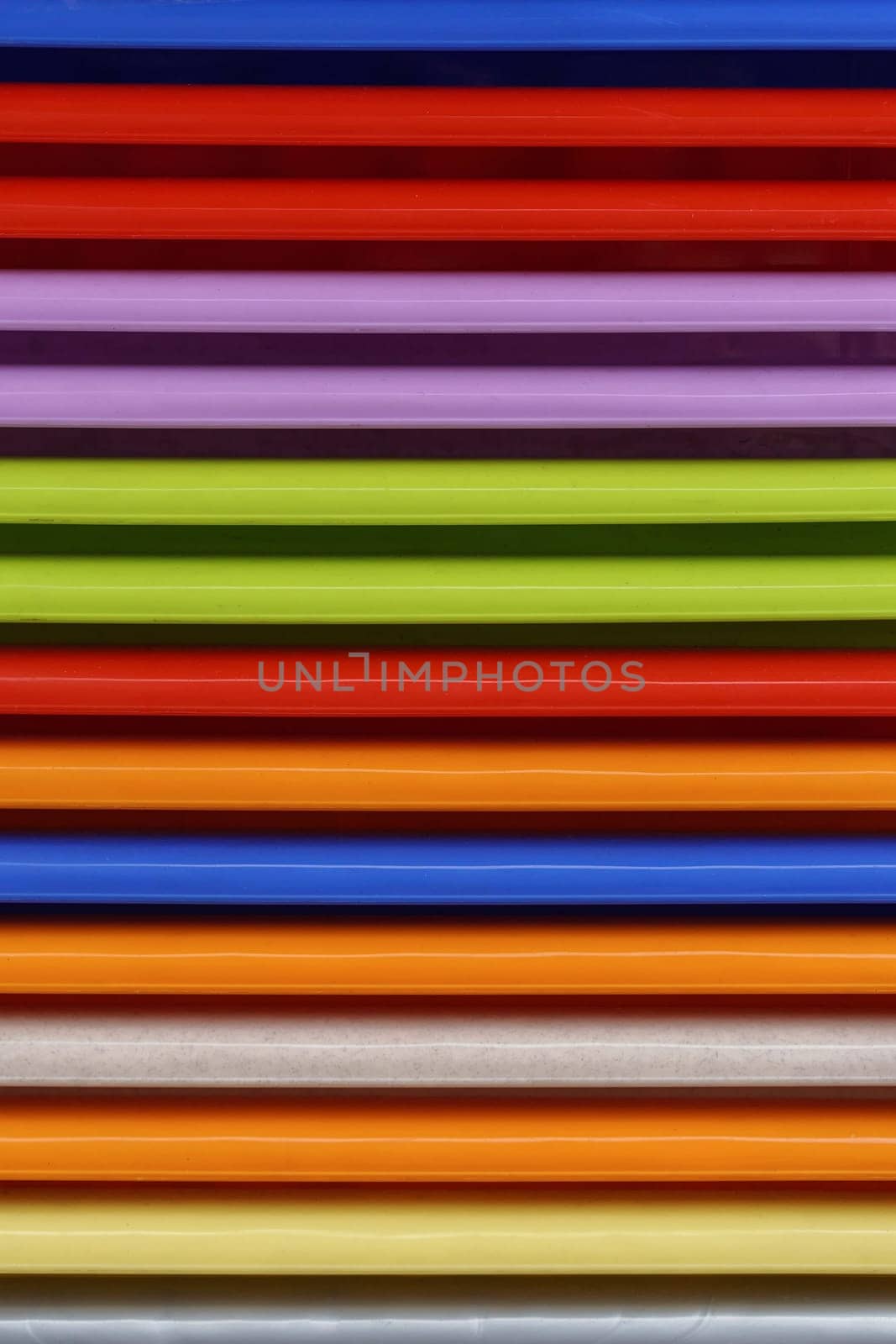 Stacked colourful plastic parts repetitive pattern