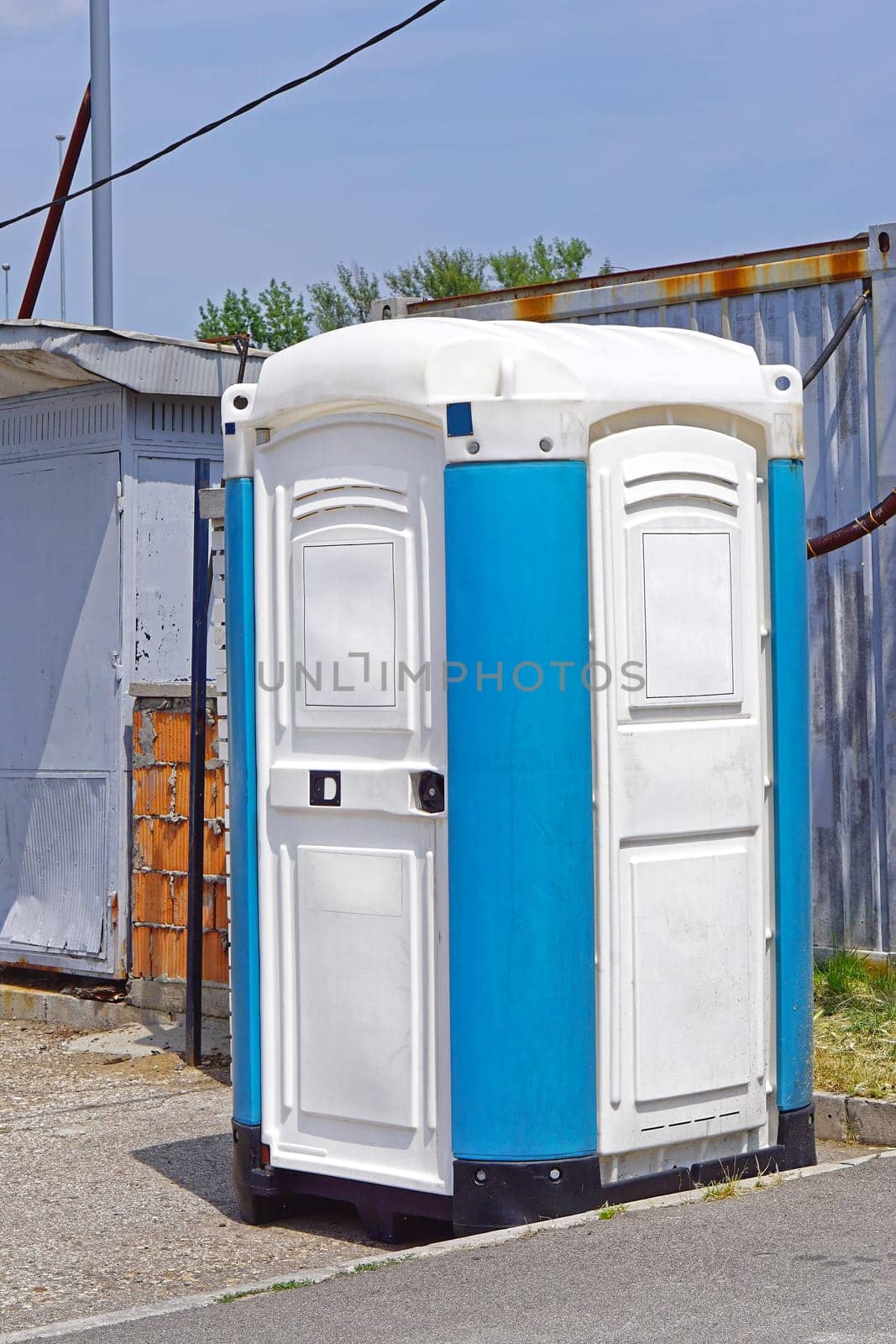 Portable toilet cabin at open construction site