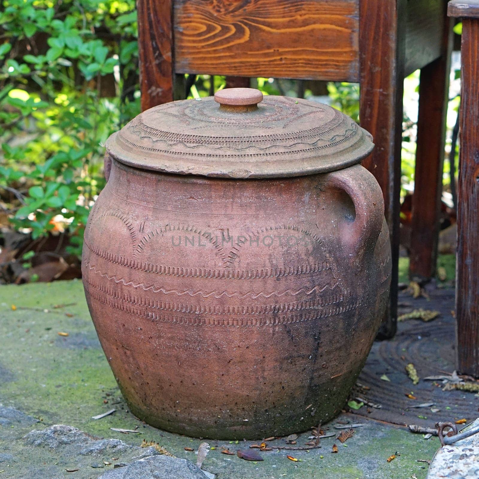 Big terracotta cooking pot with lid