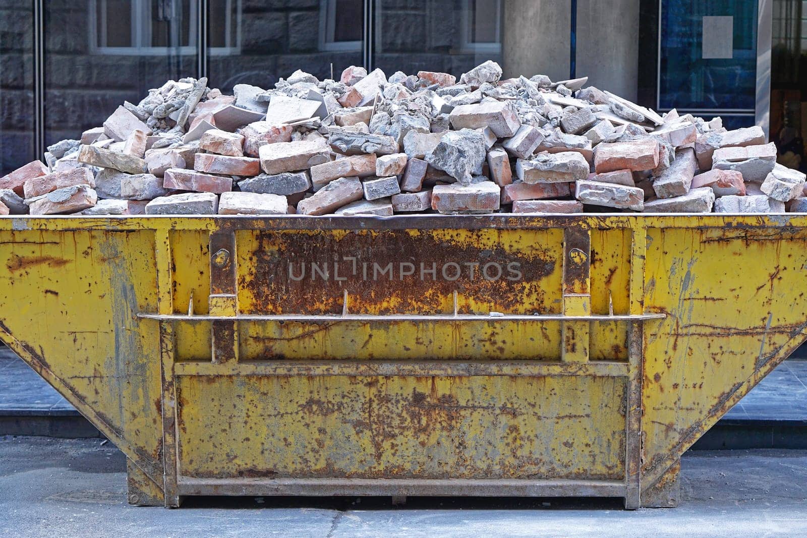 Over filled skip container with brick debris