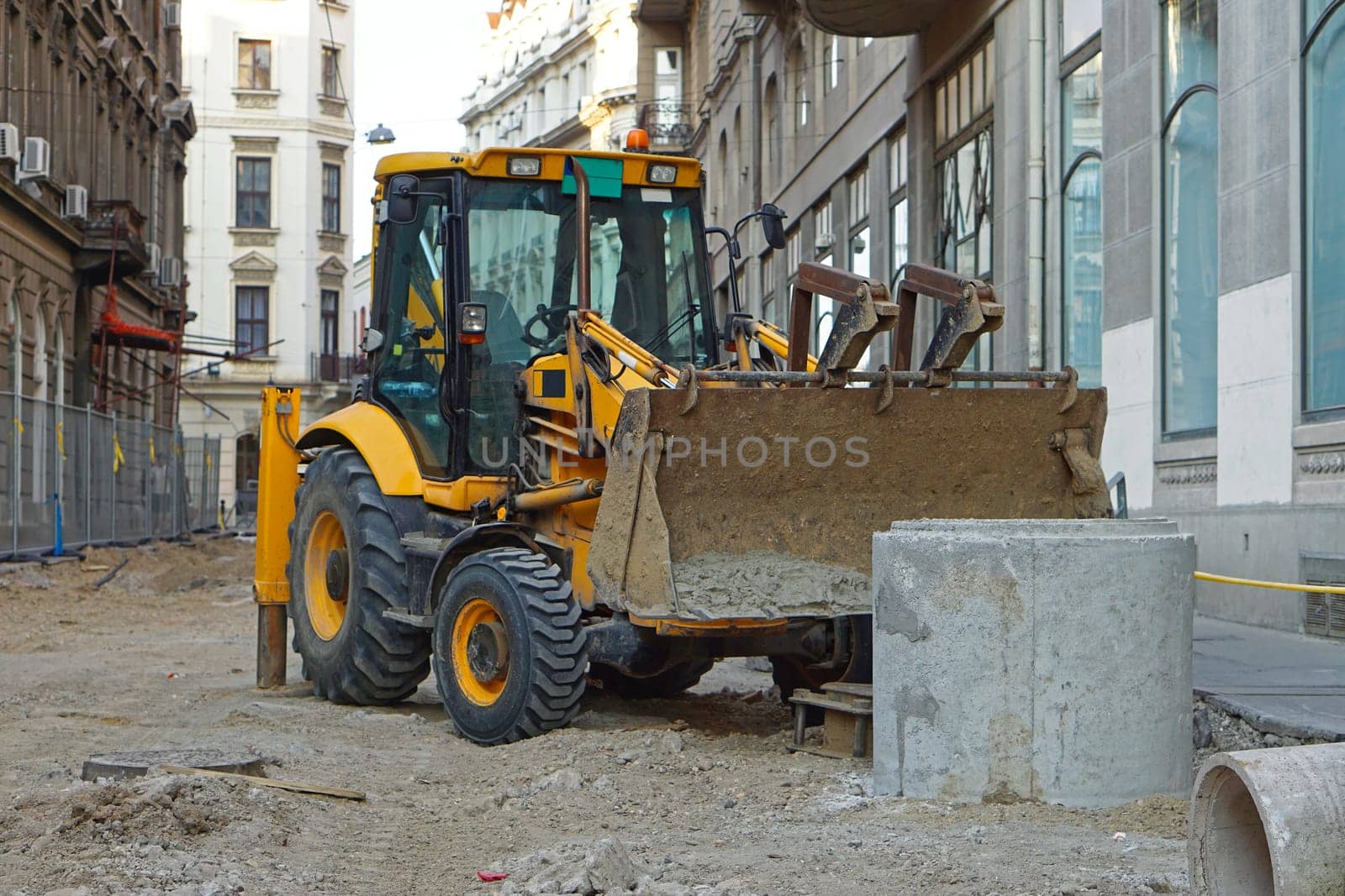 Backhoe loader at construction site in city