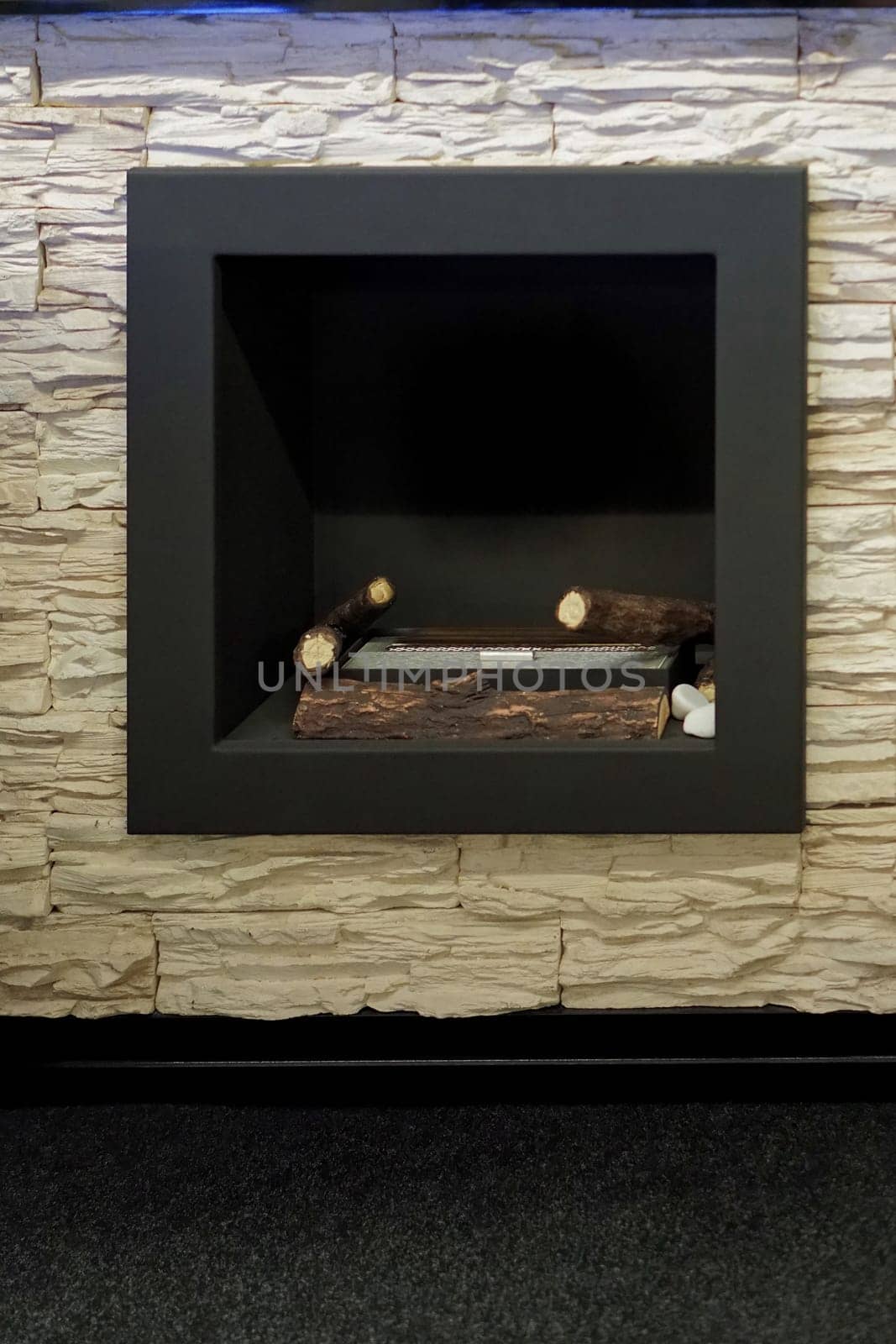 Modern black square fireplace with fake logs