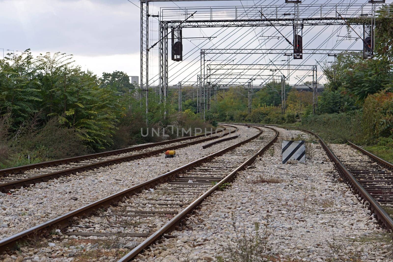 Three lane railroad with electric power lines
