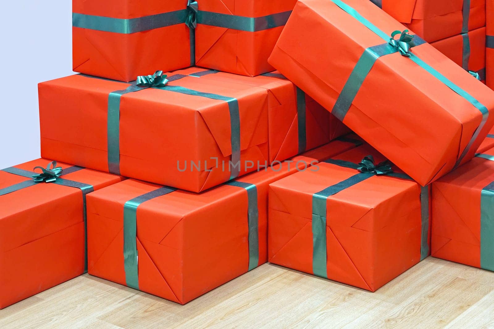 Big stack of red gifts with green ribbon