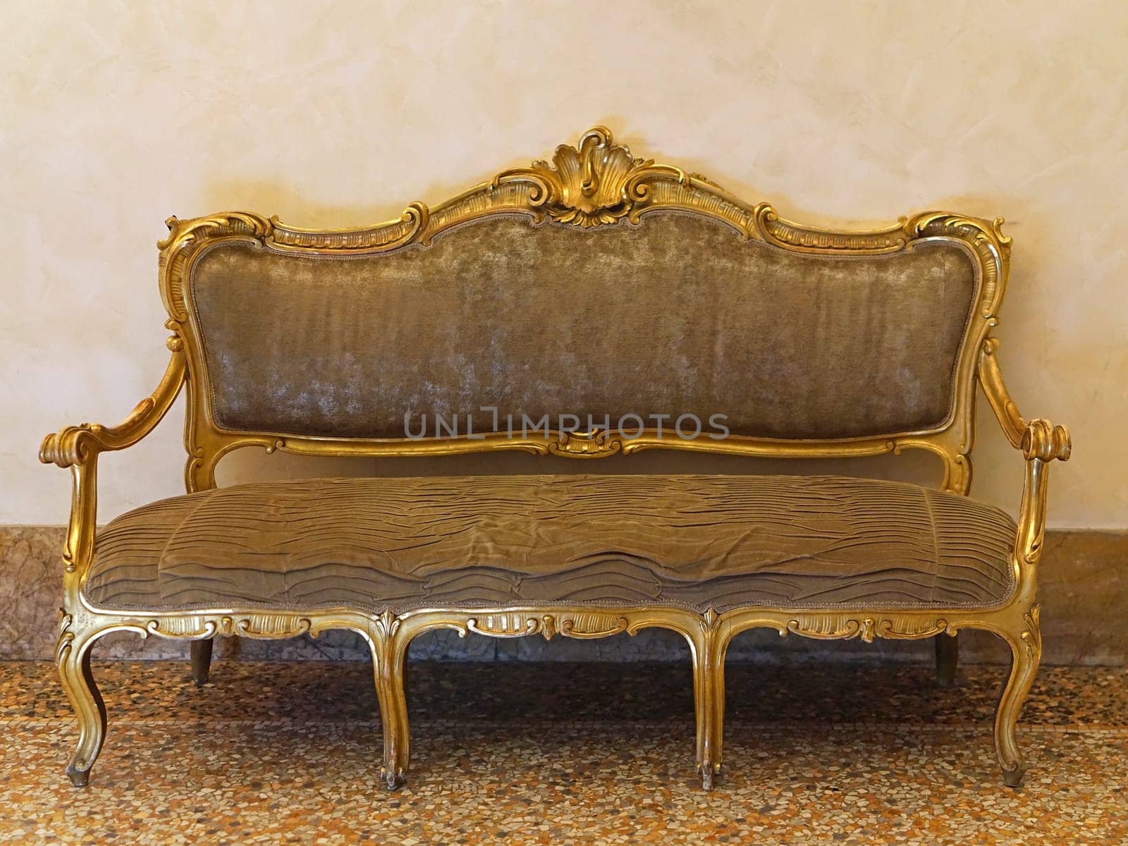Classic style golden sofa with patina