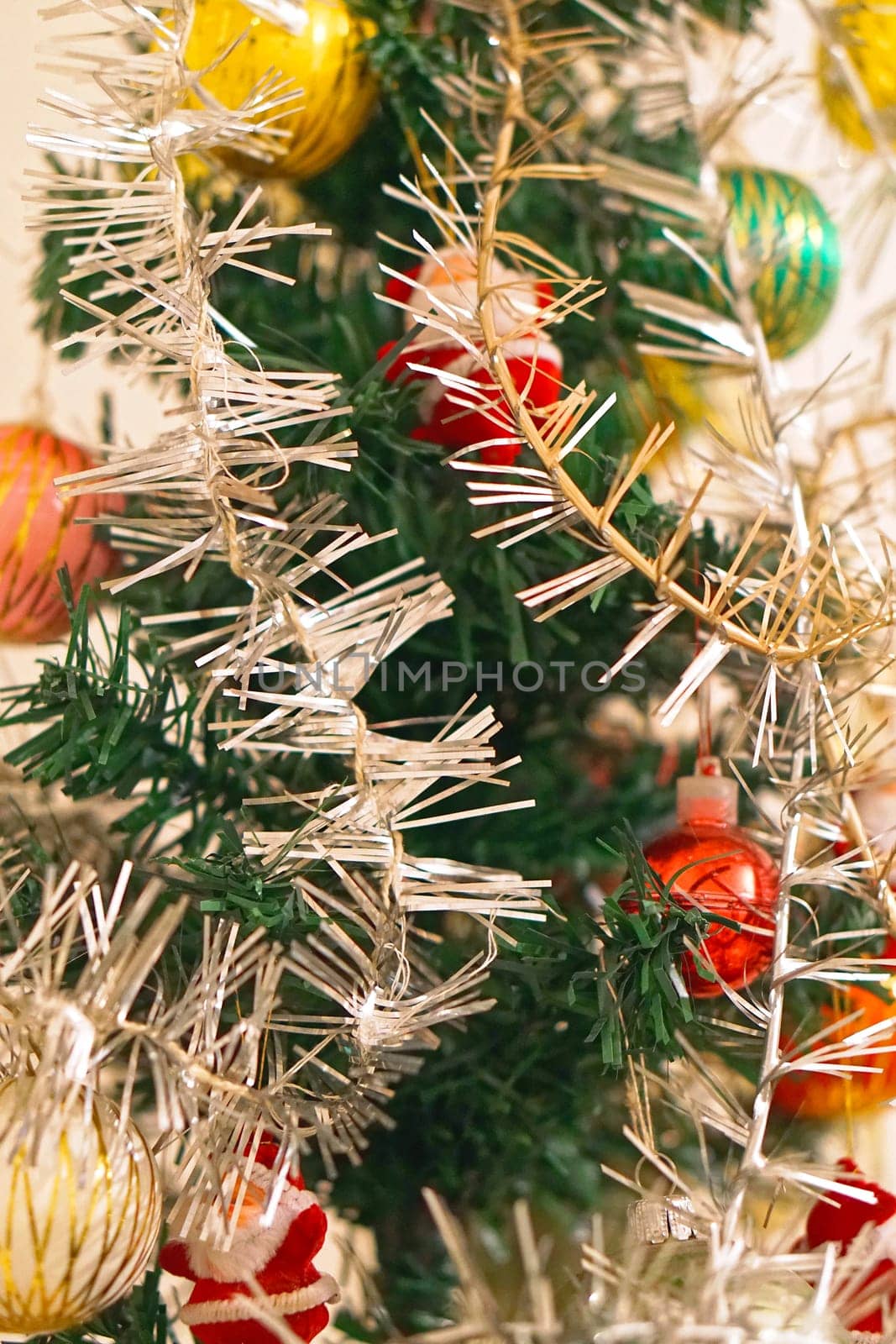 Tinsel decoration at artificial Christmas tree