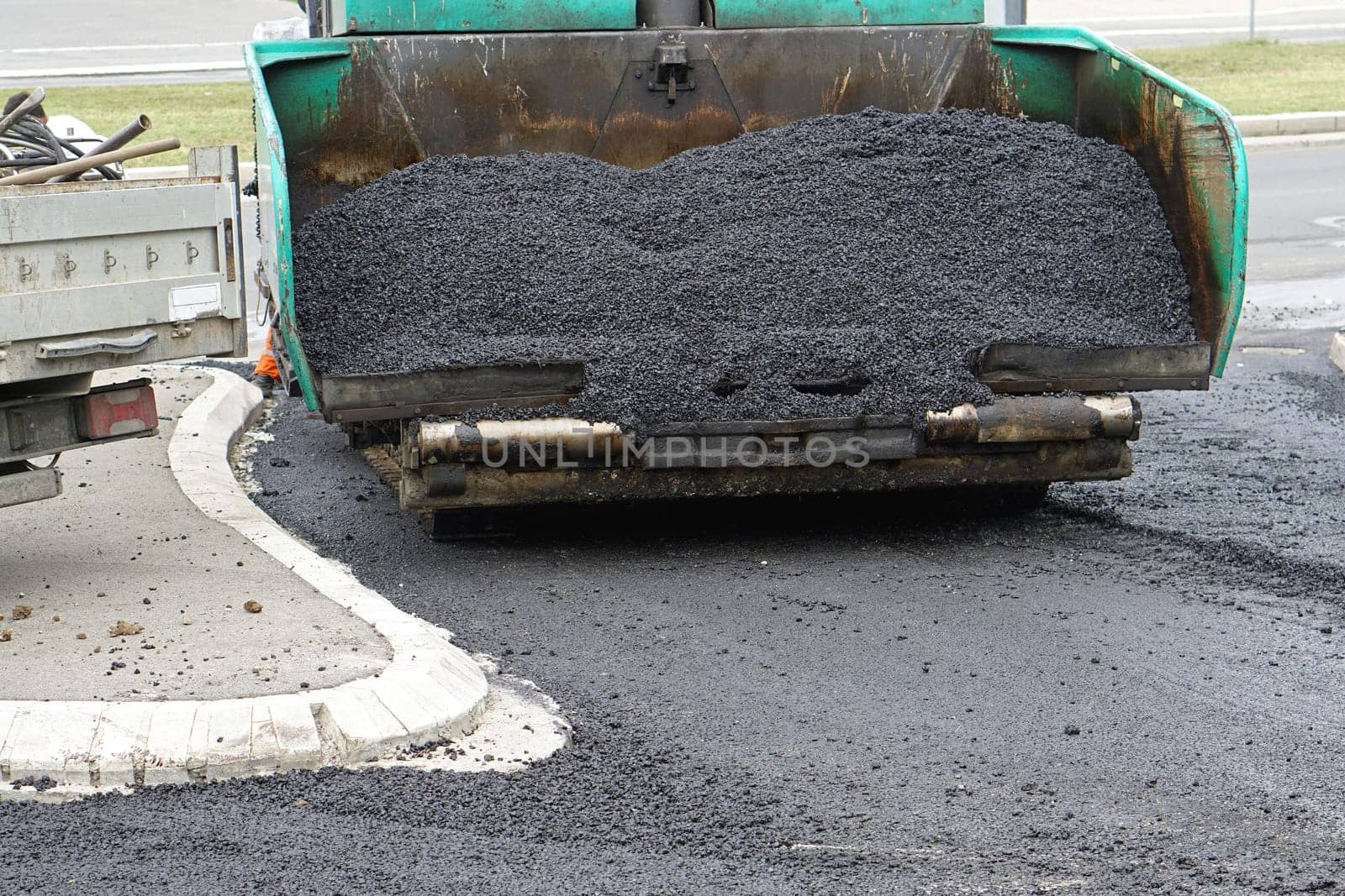 Fresh new pile of asphalt in surfacing road machine