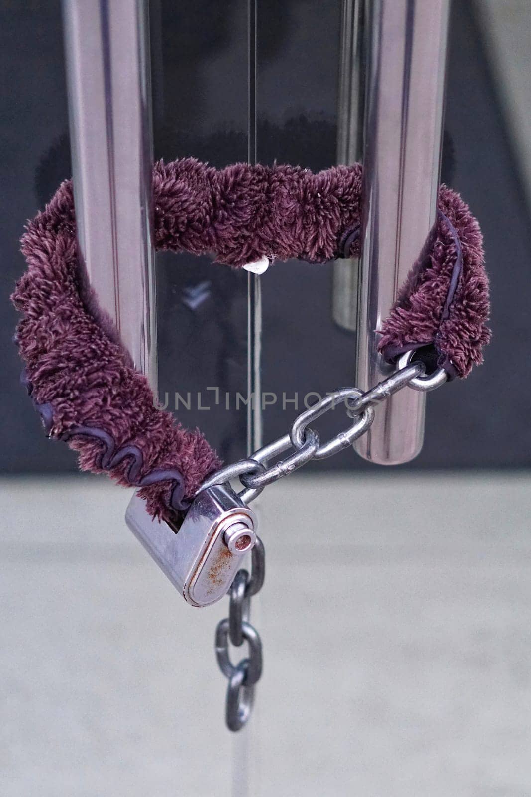 Padded chain with strong padlock at glas door