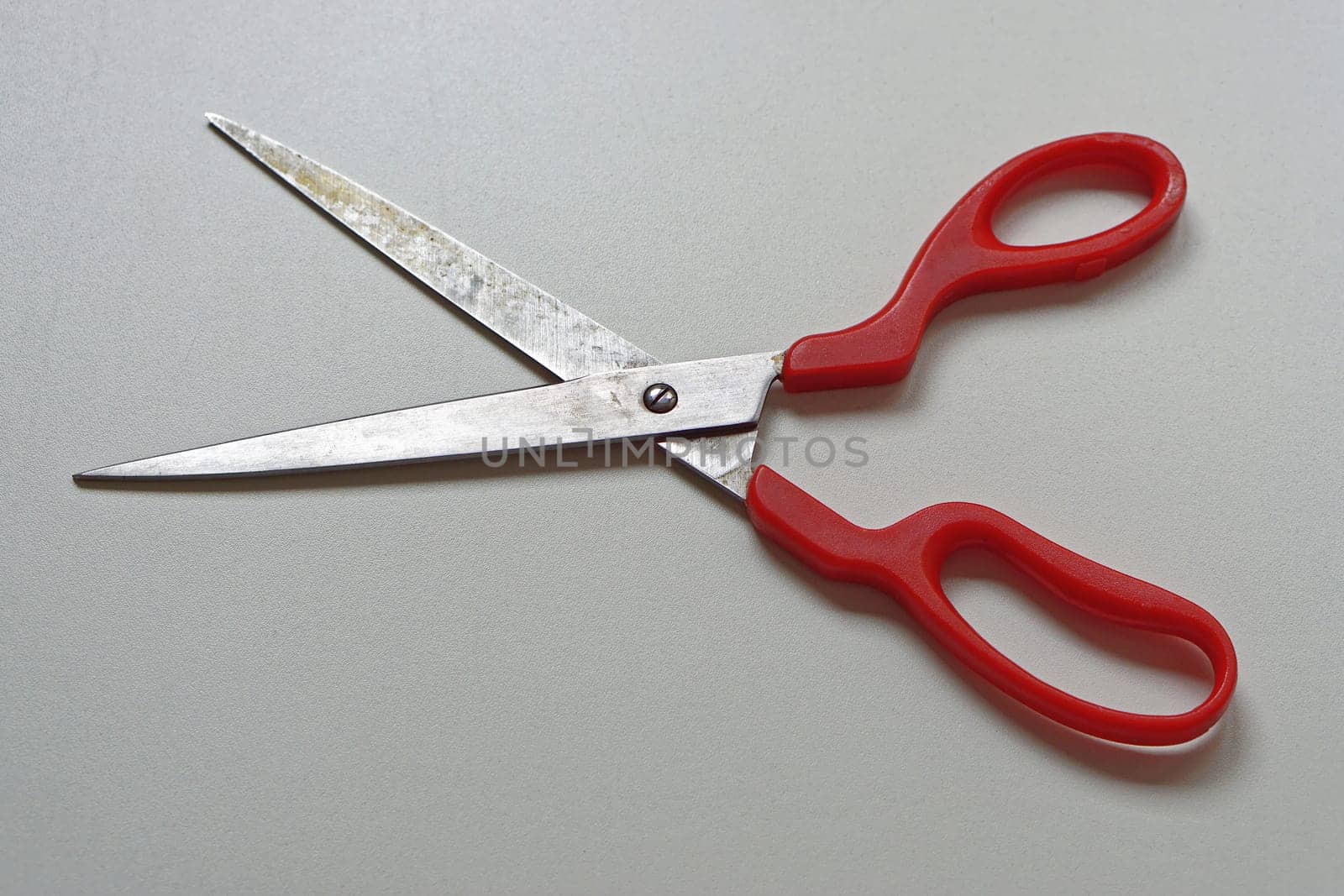 Long scissors with sharp edge and red handles