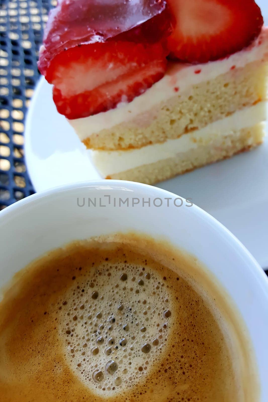 Coffee break with a cup of coffee and strawberry cake
