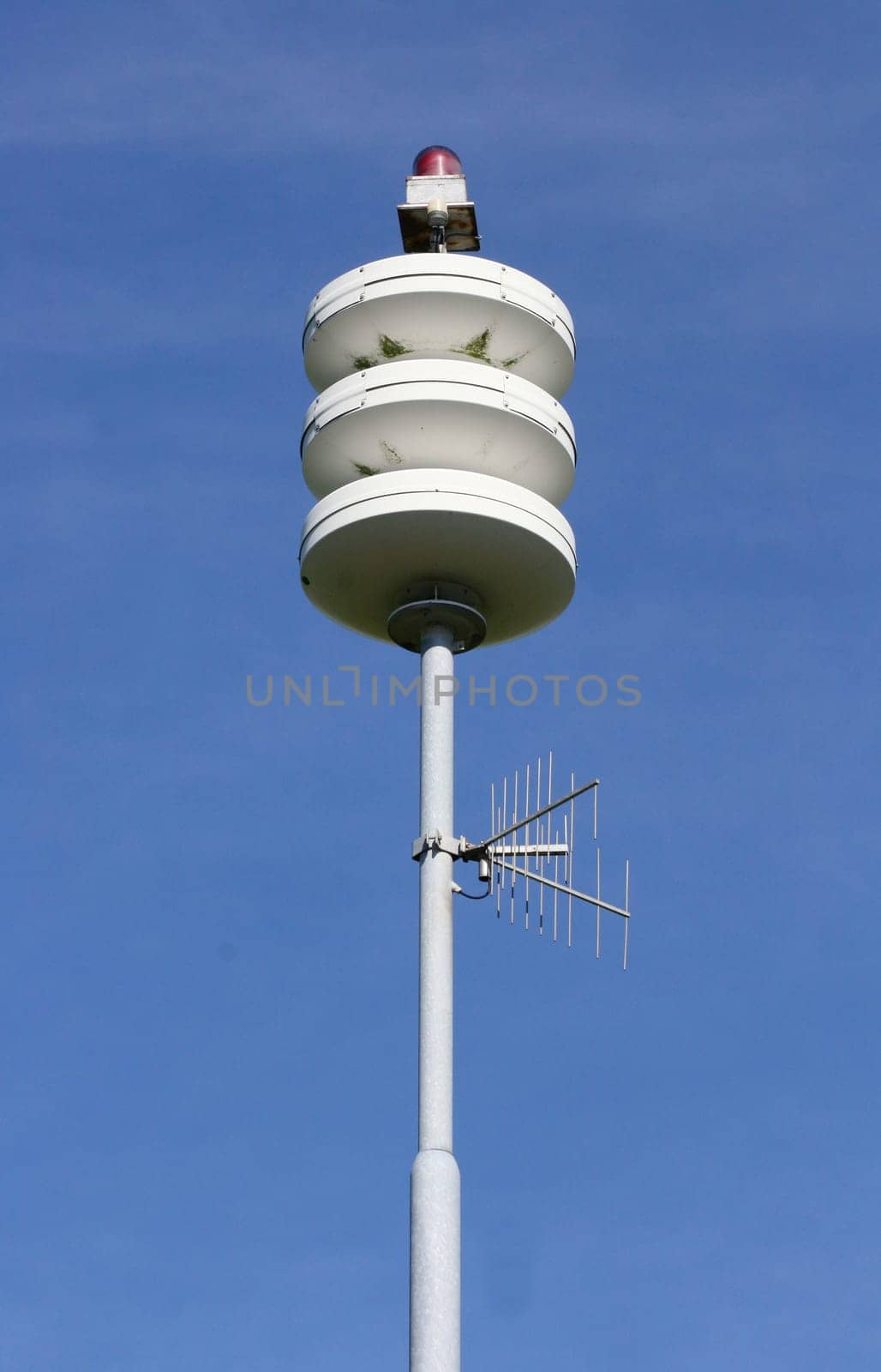 A street lamp, blue sky in the background.