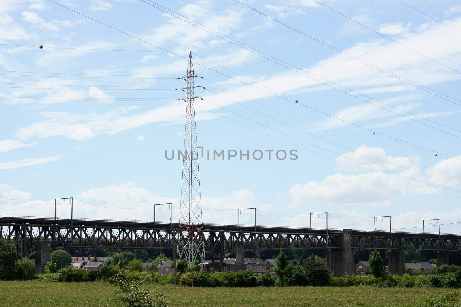 Large steel railway bridge, blue sky in the background .