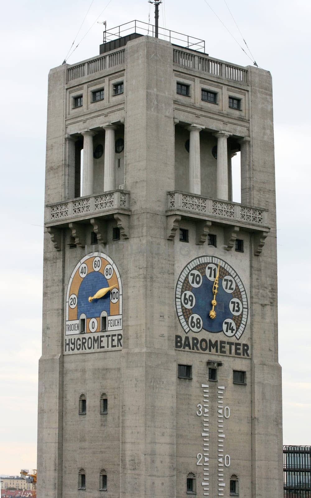A large tower with hygrometer and barometer pointer